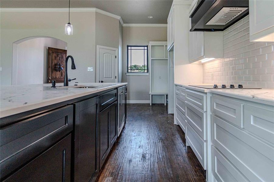 Kitchen featuring tasteful backsplash, white cabinets, sink, dark hardwood / wood-style floors, and custom range hood