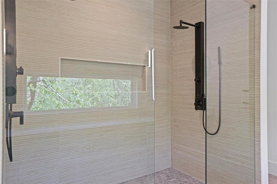 Walk in shower located in the primary bathroom.