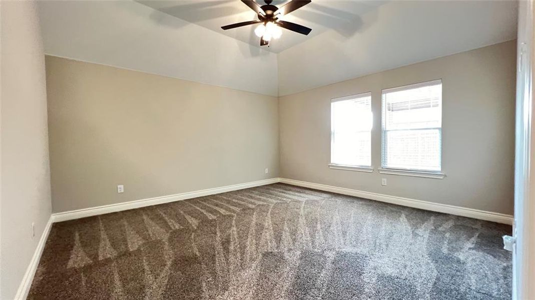 Empty room featuring ceiling fan and carpet