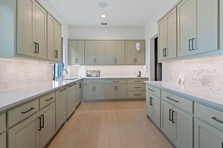 The kitchen comes equipped with this massive butler's pantry providing plenty of space for a full catering crew to set up for large entertaining functions.