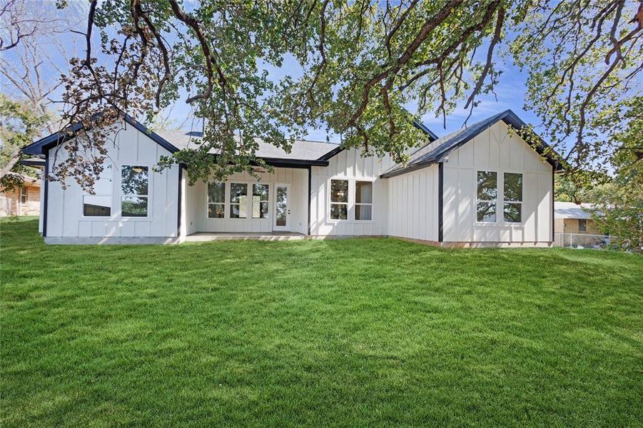 Rear view of property featuring a lawn