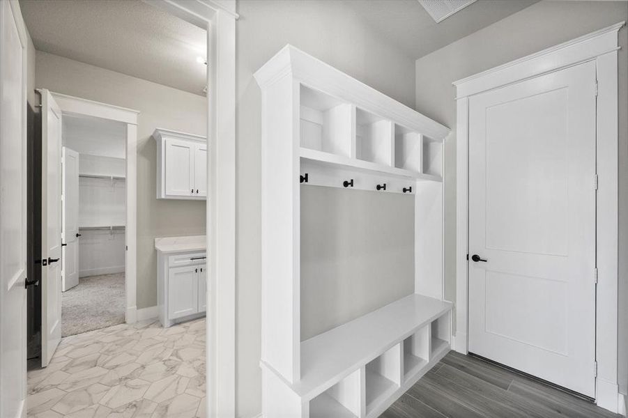 View of mudroom & laundry room connecting to primary closet