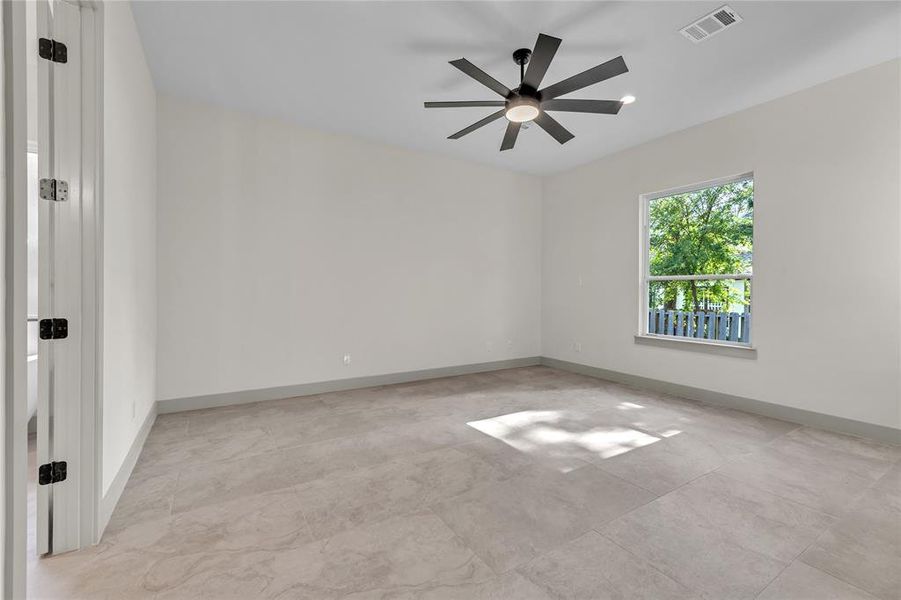 Spacious master suite with a view of the greenery outside