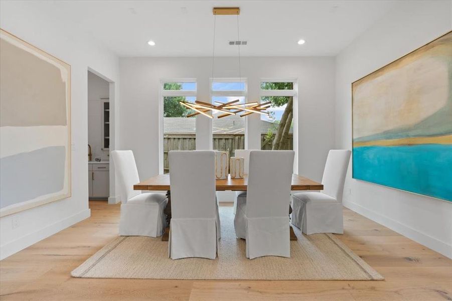 Dining room featuring a chandelier and light hardwood / wood-style floors