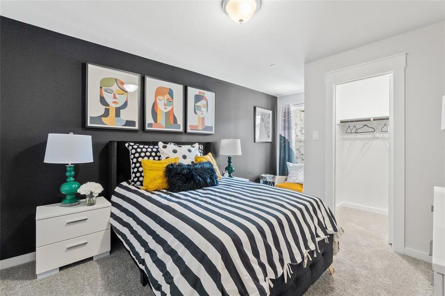 Bedroom featuring a closet, a walk in closet, and carpet floors