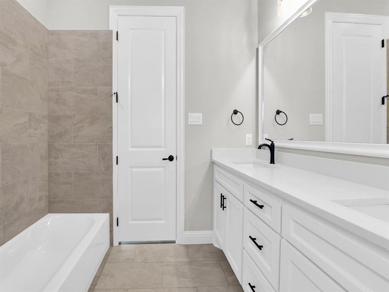 Bathroom with tile floors and dual vanity