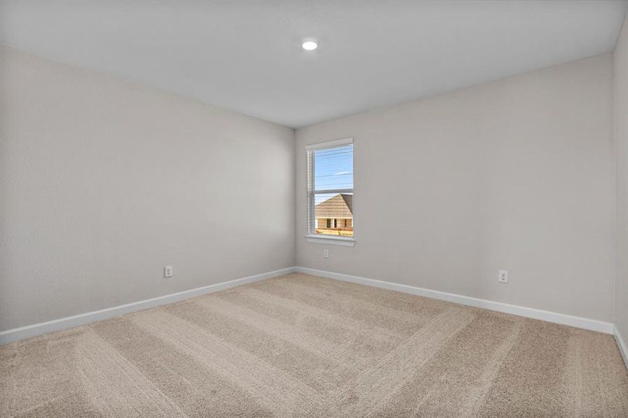 One of the two additional bedrooms in the home.