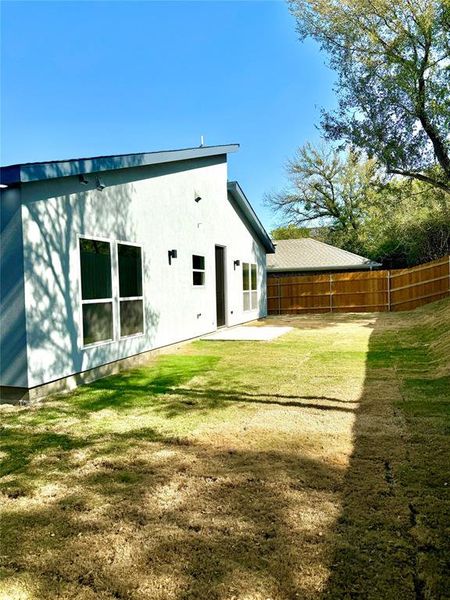 Rear view of property with a patio area and a lawn