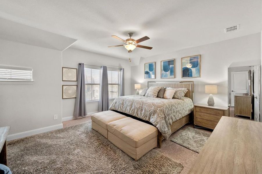 Carpeted bedroom with ceiling fan