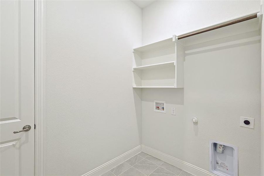 Laundry room featuring washer hookup, hookup for a gas dryer, light tile patterned floors, and electric dryer hookup