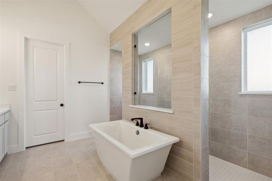 This fantastic owner's bath features our signature freestanding tub with walk through shower!