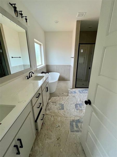 Bathroom with double sink vanity and independent shower and bath