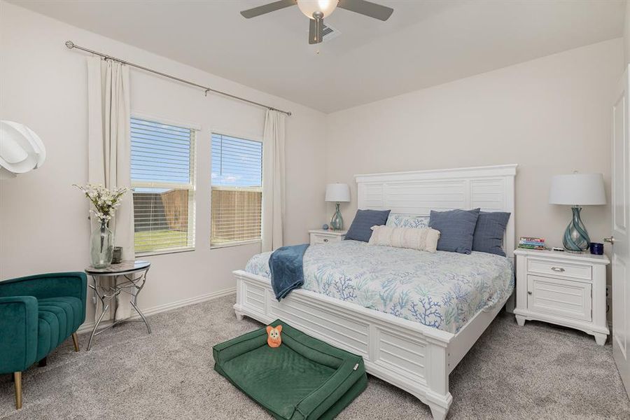 Bedroom featuring light carpet and ceiling fan