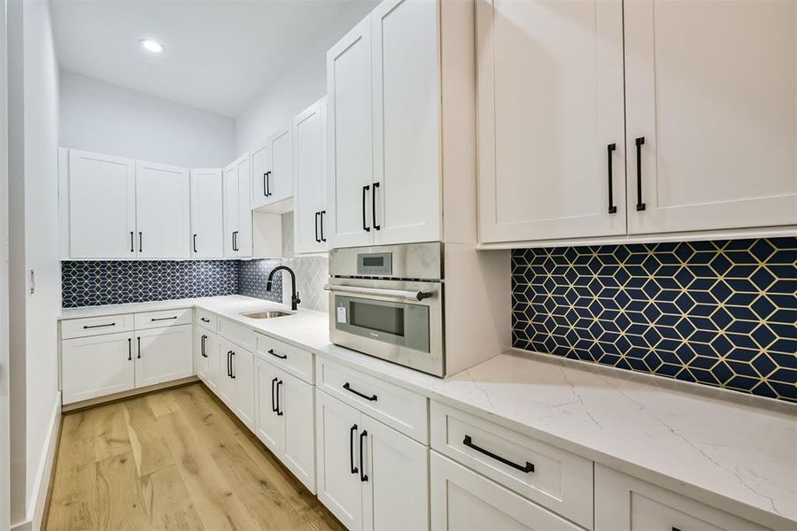 Butler's Pantry features a plethora of Cabinet and Countertop Space, and a Microwave