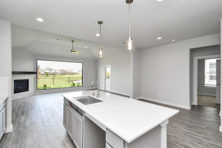 All of this overlooks your expansive family room, creating a perfect space for culinary delights and family gatherings. Sample photo of completed home with similar floor plan. Actual colors and selections may vary.