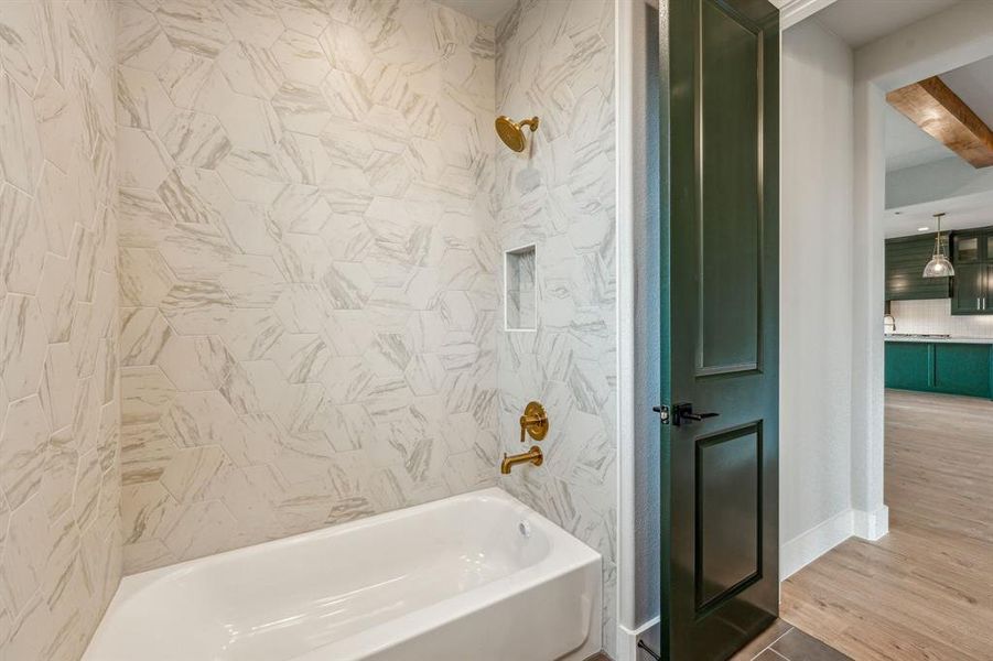 Bathroom with beam ceiling, tiled shower / bath, and hardwood / wood-style floors