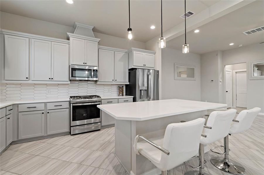 Kitchen is a chef's delight, boasting granite countertops, stainless steel appliances including a range and microwave