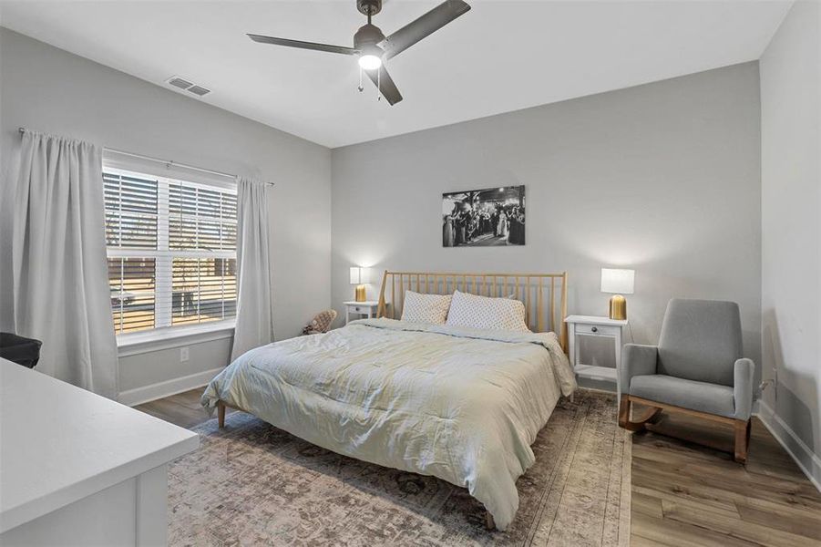 Bedroom featuring ceiling fan and hardwood / wood-style flooring