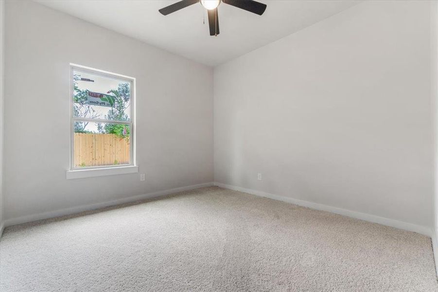 Spare room with carpet and ceiling fan