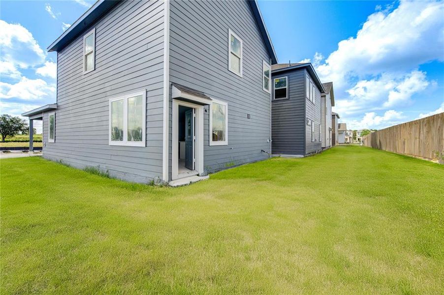 Step outside to a spacious backyard that offers endless possibilities for outdoor living. Whether you envision a garden, play area, or entertaining space, this yard provides the perfect setting for your outdoor lifestyle. **This image is from another Saratoga Home - Athena floorplan.**