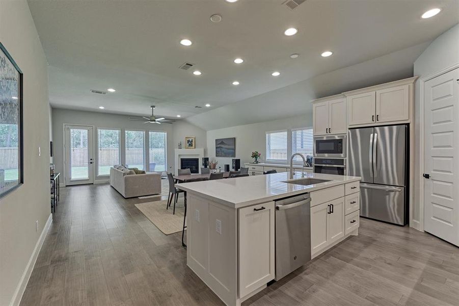 Kitchen opens to family room for ease of entertaining.  Note the upgraded drawers (including hardware) in the kitchen to include pots/pans drawers and trash pull out.