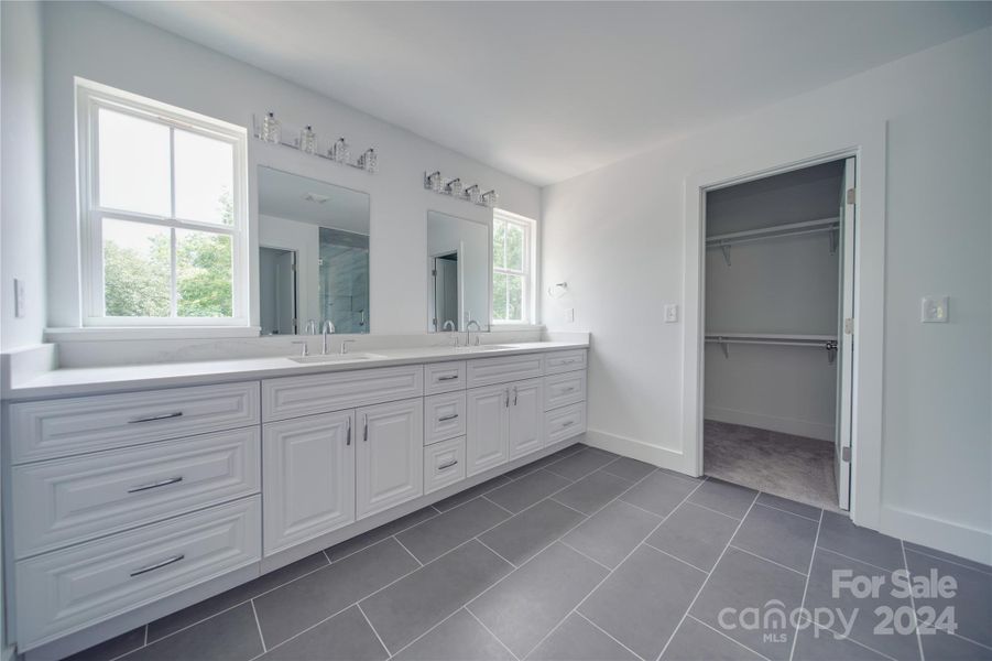 PRIMARY BATHROOM WITH TONS OF COUNTERTOP SPACE AND DUAL SINKS