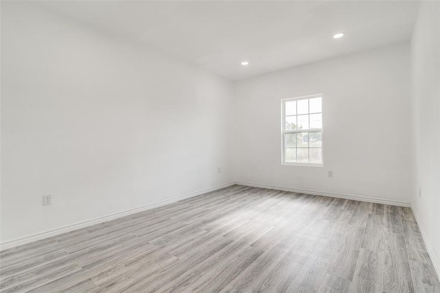 Unfurnished room with light hardwood / wood-style flooring