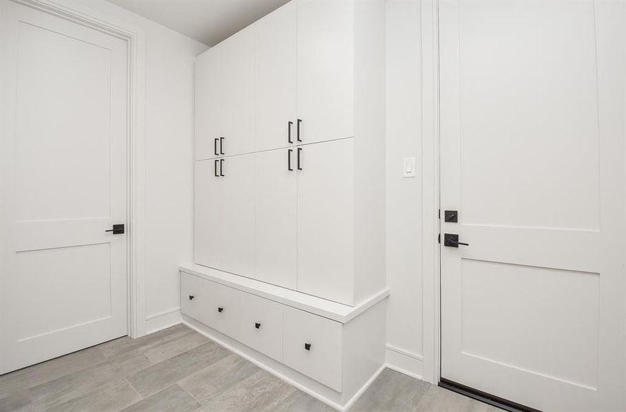 This handy mud room right off the garage just behind the kitchen with a half bath.