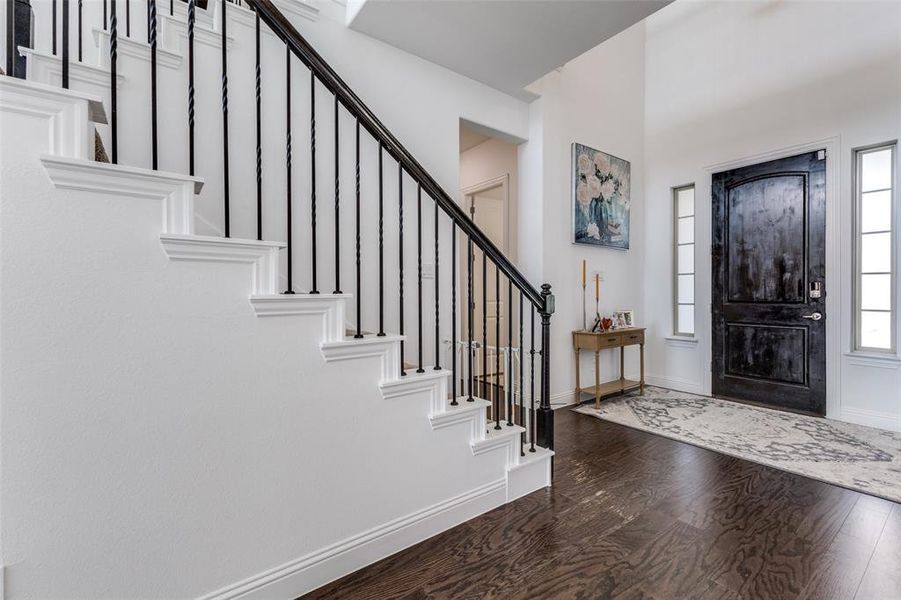 Entrance foyer featuring wood floors