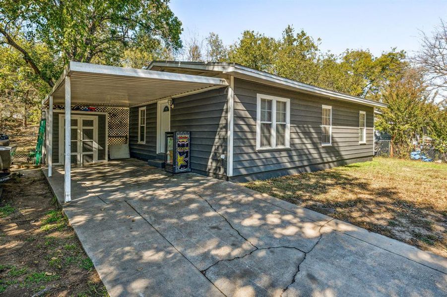 Rear view of property featuring a carport