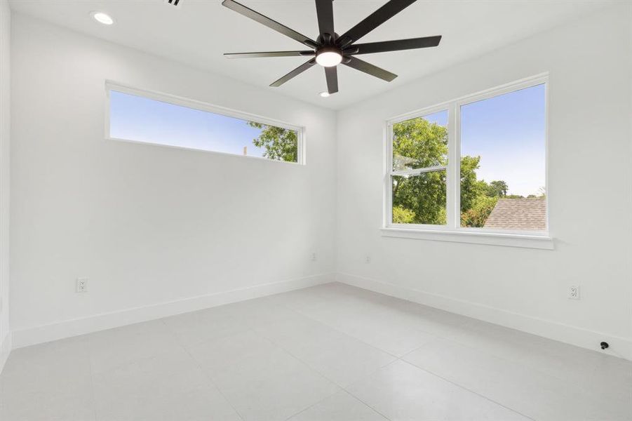 Unfurnished room featuring tile flooring and ceiling fan