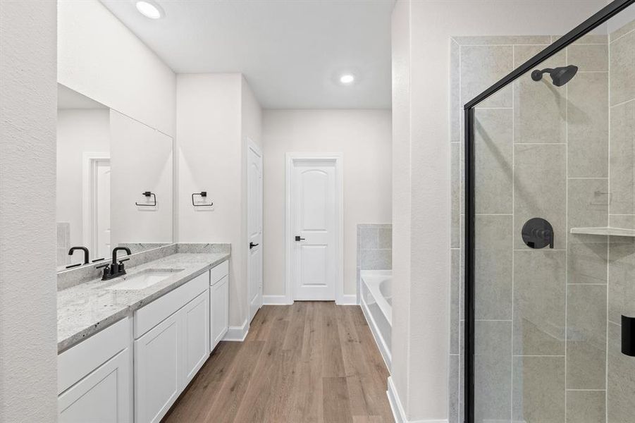 Bathroom featuring a separate tub and shower.