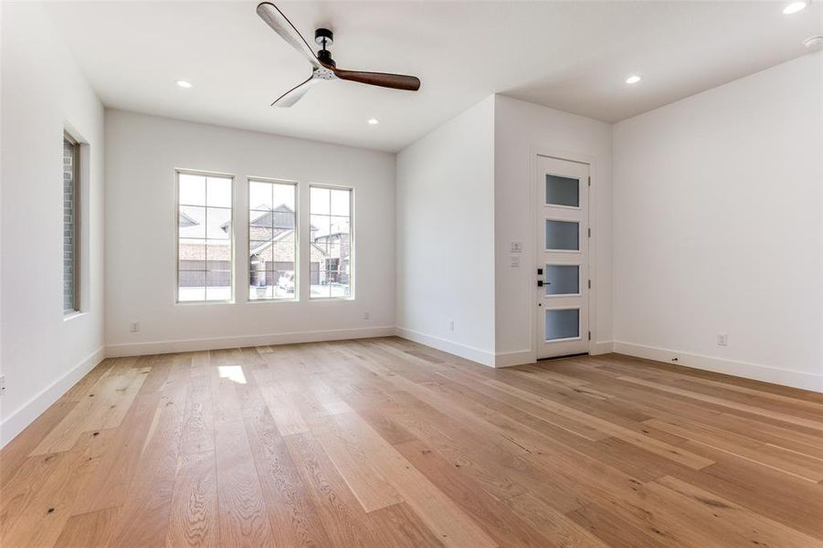 Empty room featuring ceiling fan and light hardwood / wood-style flooring