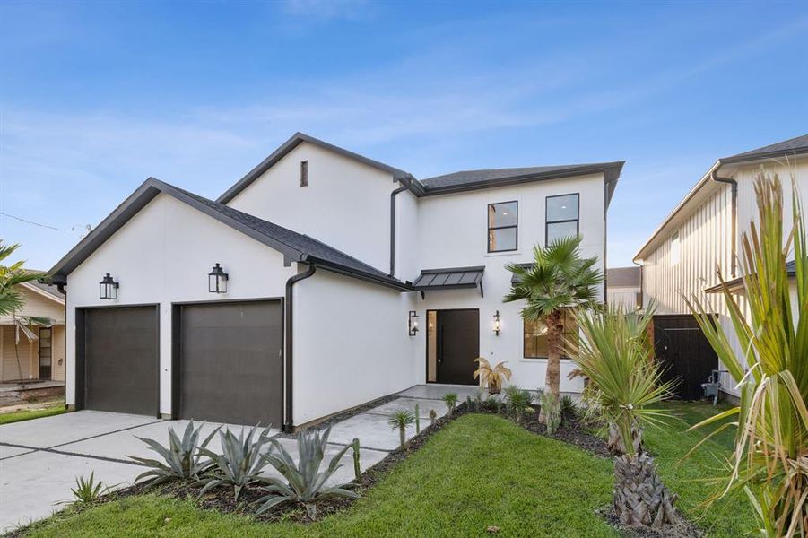 View of front of home with a front yard and a garage