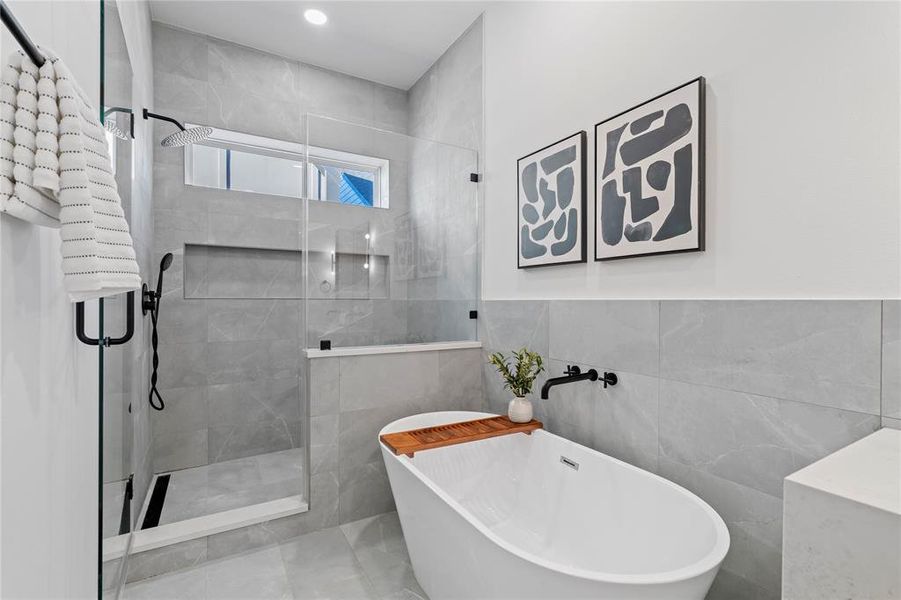 Enjoy a luxurious soak in the freestanding tub or a refreshing rinse in the elegant glass shower. This bathroom’s calming gray tones and refined details make it a perfect escape for relaxation and rejuvenation.