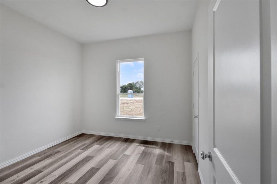 Empty room with light hardwood / wood-style floors