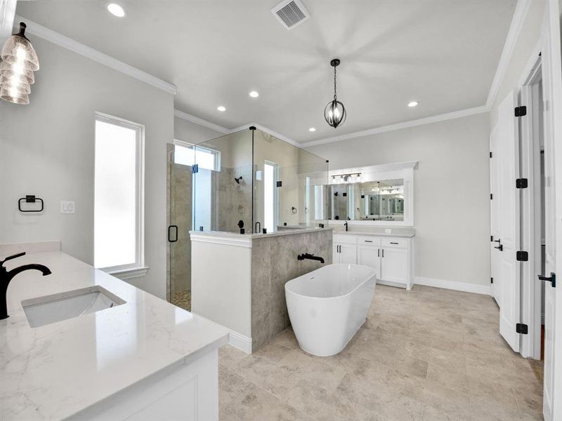 Bathroom with vanity, crown molding, and shower with separate bathtub