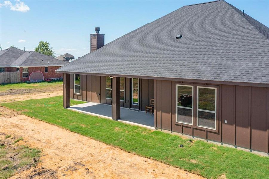 Rear view of property featuring a patio area and a yard