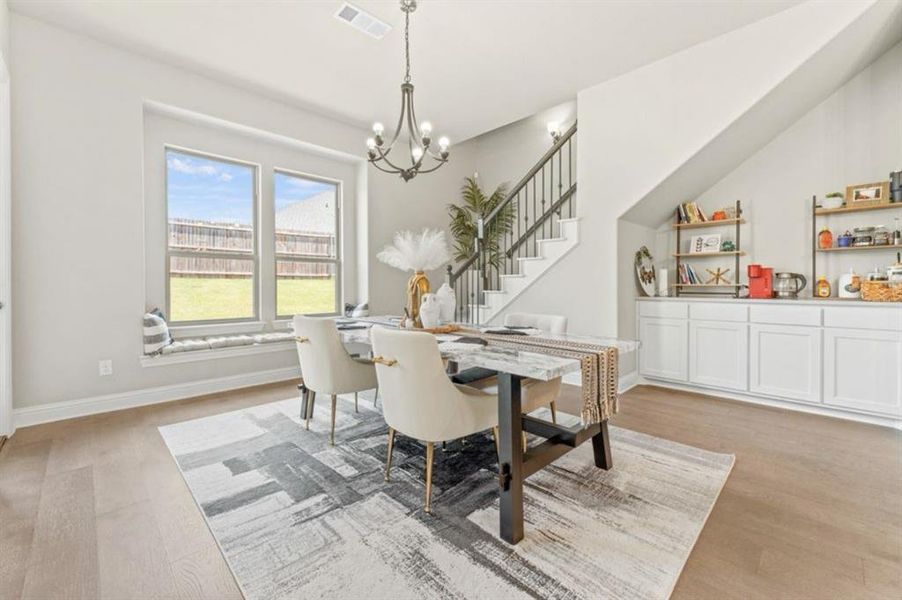 Dining space featuring a notable chandelier and light hardwood / wood-style flooring