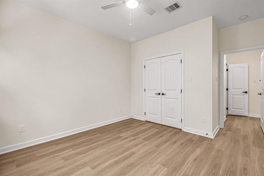 This guest bedroom also has a double door closet.