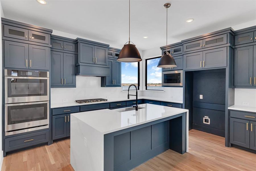 This gourmet kitchen is a delight for any chef! Quartz counters, gas cooktop, double ovens and plenty of cabinet and counter space will amaze you.