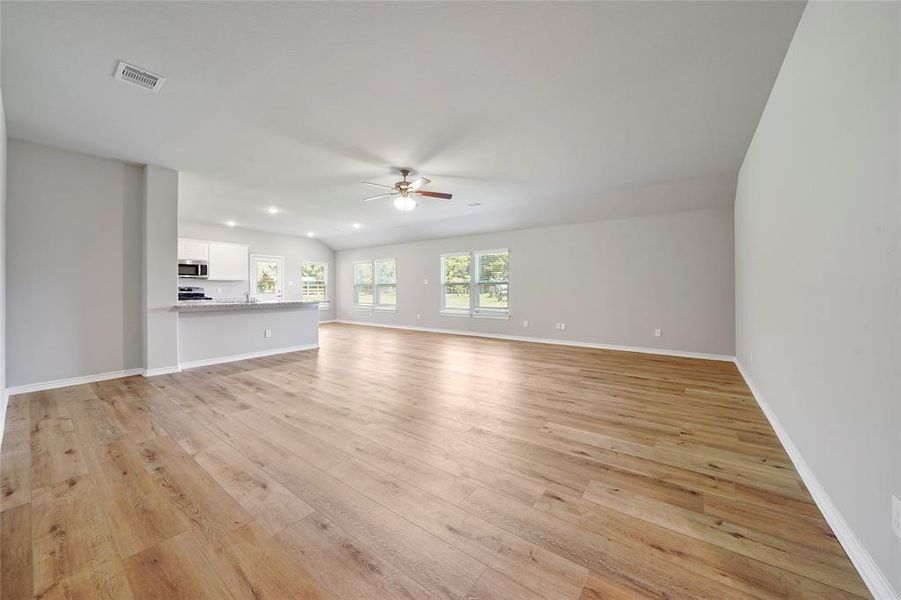 Looking into the massive living room area and into the kitchen