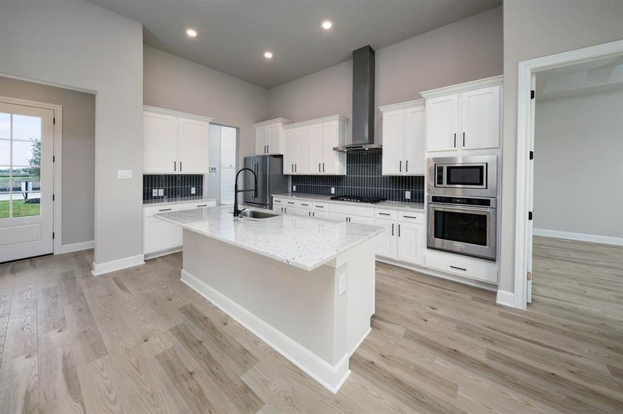 Directly off the family room is the fully-loaded kitchen, designed to be both beautiful and functional.