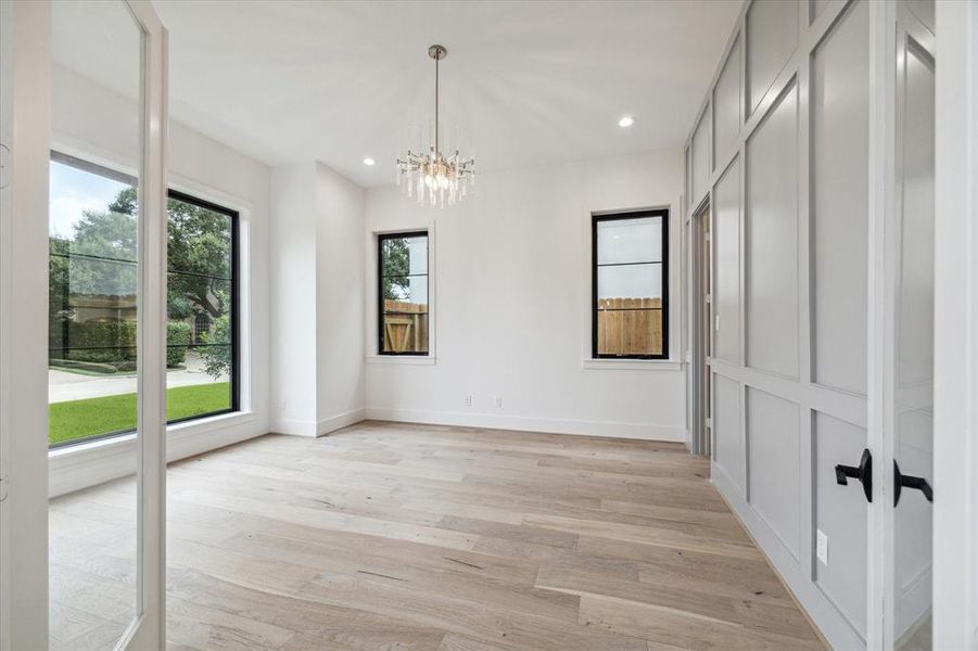 Study or formal living room with block-panelled accent wall and storage closet.