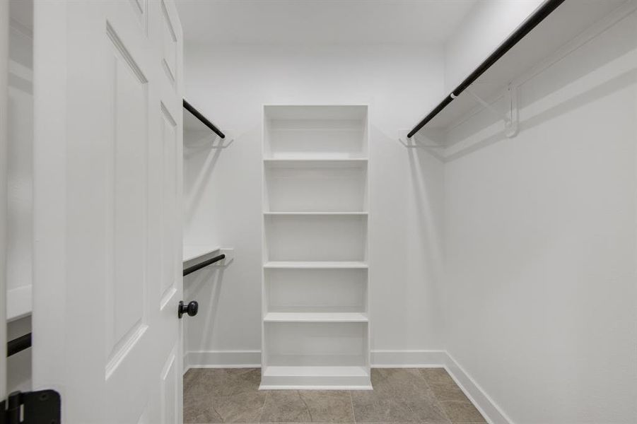 Large walk in closet with built in shelves