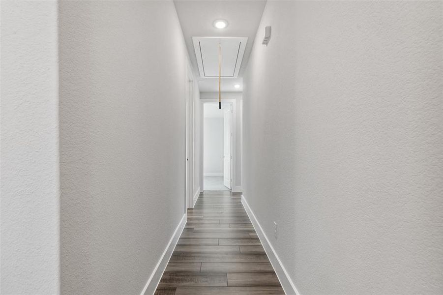 Hallway with dark hardwood / wood-style floors