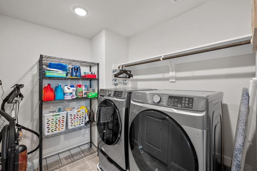 Washroom featuring washing machine and dryer and tile patterned flooring