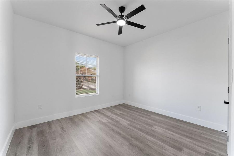 Spare room with light hardwood / wood-style floors and ceiling fan