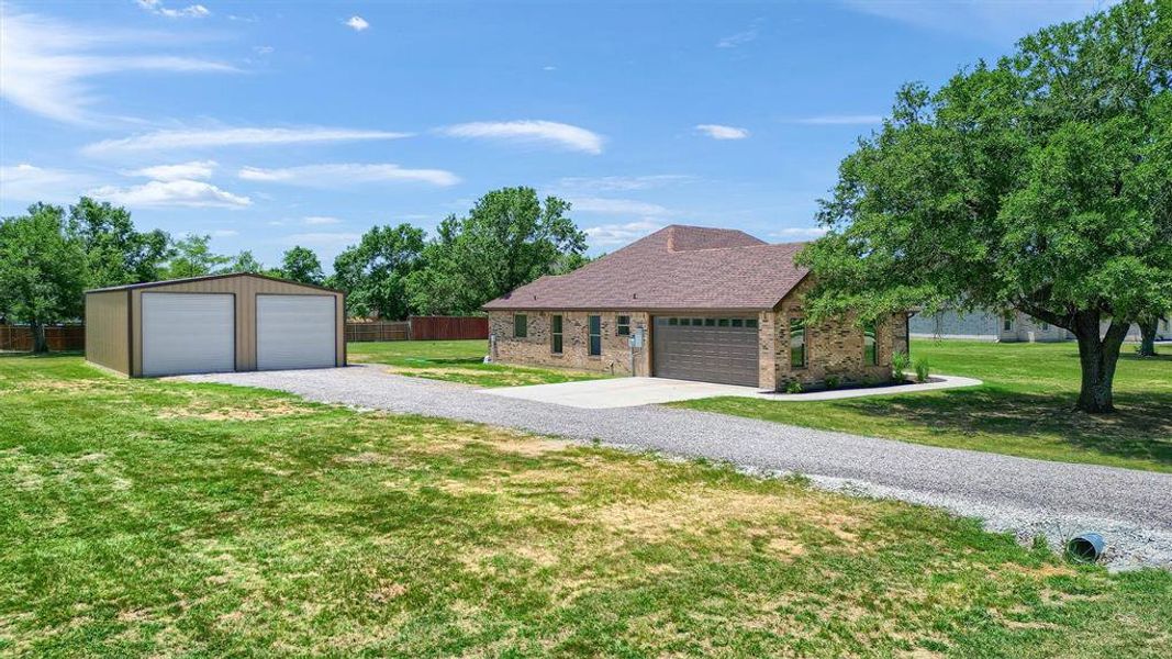 Single story home featuring a garage and a front lawn