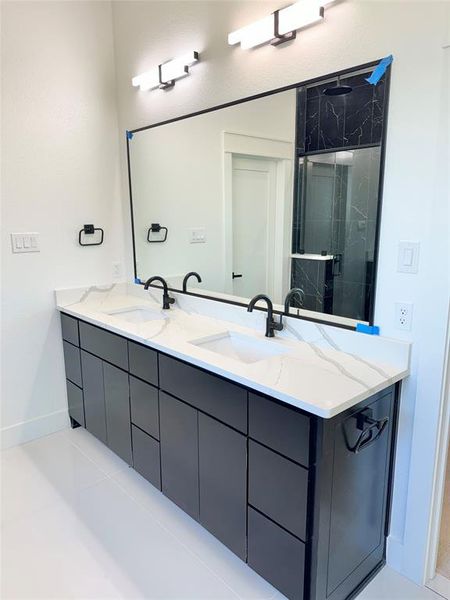 Bathroom featuring vanity and tiled shower